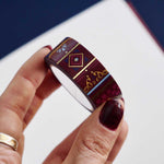 Roll of red washi tape with light blue and pink flowers, diamonds, filagree and gold foil