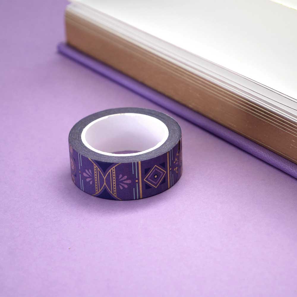 Roll of purple washi tape with light blue, pink and dark purple accents and gold foil