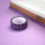 Roll of purple washi tape with light blue, pink and dark purple accents and gold foil