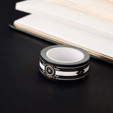 Black washi tape with white, grey and gold flowers, a white band and gold foil filagree