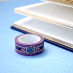Purple washi tape with blue and gold  flowers, a blue band and gold foil filagree
