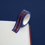 Blue washi tape with pink and gold  flowers, a red band and gold foil filagree