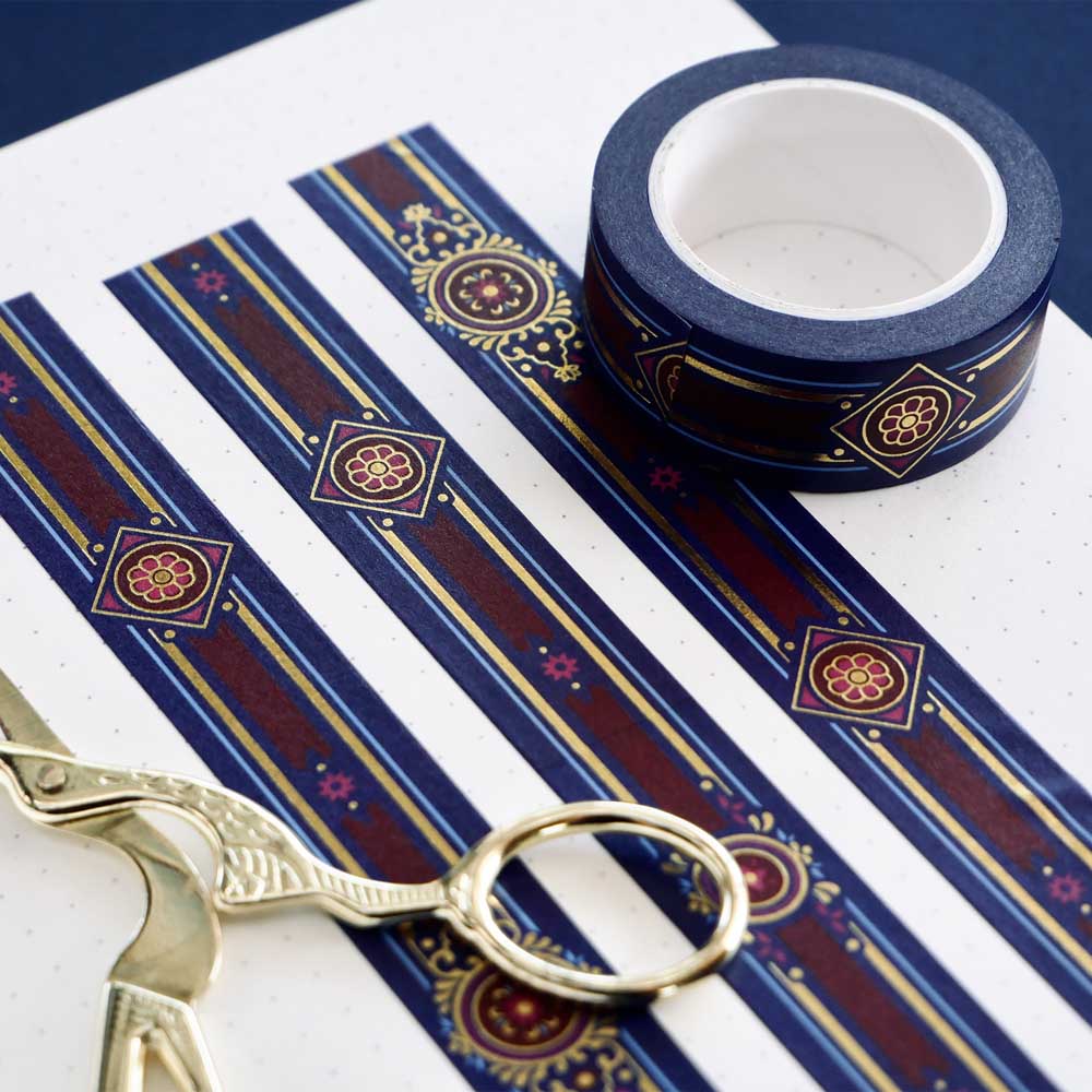 Blue washi tape with pink and gold flowers, a red band and gold foil filagree