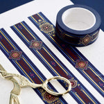 Blue washi tape with pink and gold  flowers, a red band and gold foil filagree