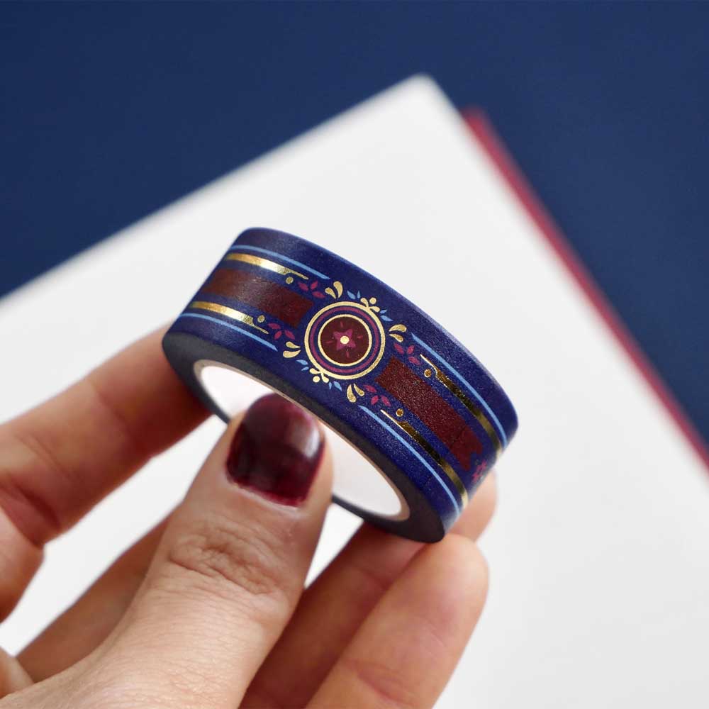 Blue washi tape with pink and gold flowers, a red band and gold foil filagree