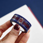 Blue washi tape with pink and gold  flowers, a red band and gold foil filagree