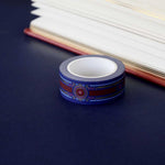 Blue washi tape with pink and gold  flowers, a red band and gold foil filagree