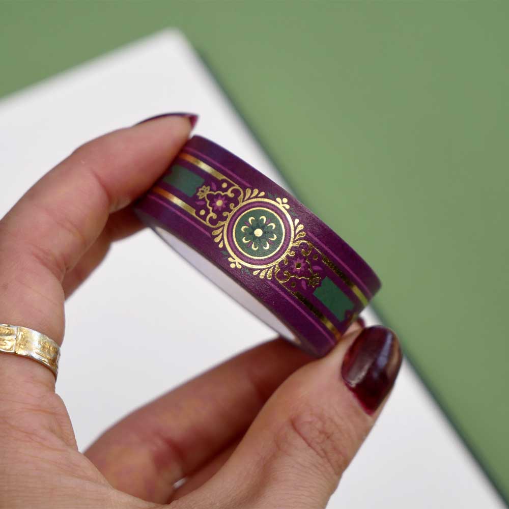 Purple washi tape with pink, gold and green flowers, a green band and gold foil filagree