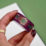 Purple washi tape with pink, gold and green flowers, a green band and gold foil filagree