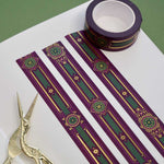 Purple washi tape with pink, gold and green flowers, a green band and gold foil filagree