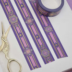 Purple washi tape with pink and gold  flowers, a pink band and gold foil filagree