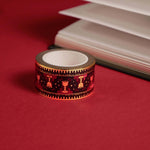 Blood Spilled- a fantasy book washi tape by The Quirky Cup Collective- is displayed on a red background. The bookish washi tape design is red and black with gold detailing with a goblet motif.