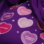 purple canvas tote bag covered in candy hearts and stars. The stars are in shades of purple, pink and red and refer to common romance fantasy book tropes