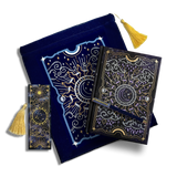 a bundle of items that include a bookmark, a book sleeve, a journal and a pen. Sitting on a plain background