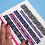 Washi tapes with blue and purple backgrounds with pink and blue flowers and gold foil
