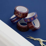 Five rolls of washi tape with red and blue backgrounds with flowers and gold foil