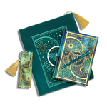 bundle of teal blue stationery items on a plain background. Items are a book sleeve, journal, pen and bookmark. Design features a luna moth with celestial inspired design.