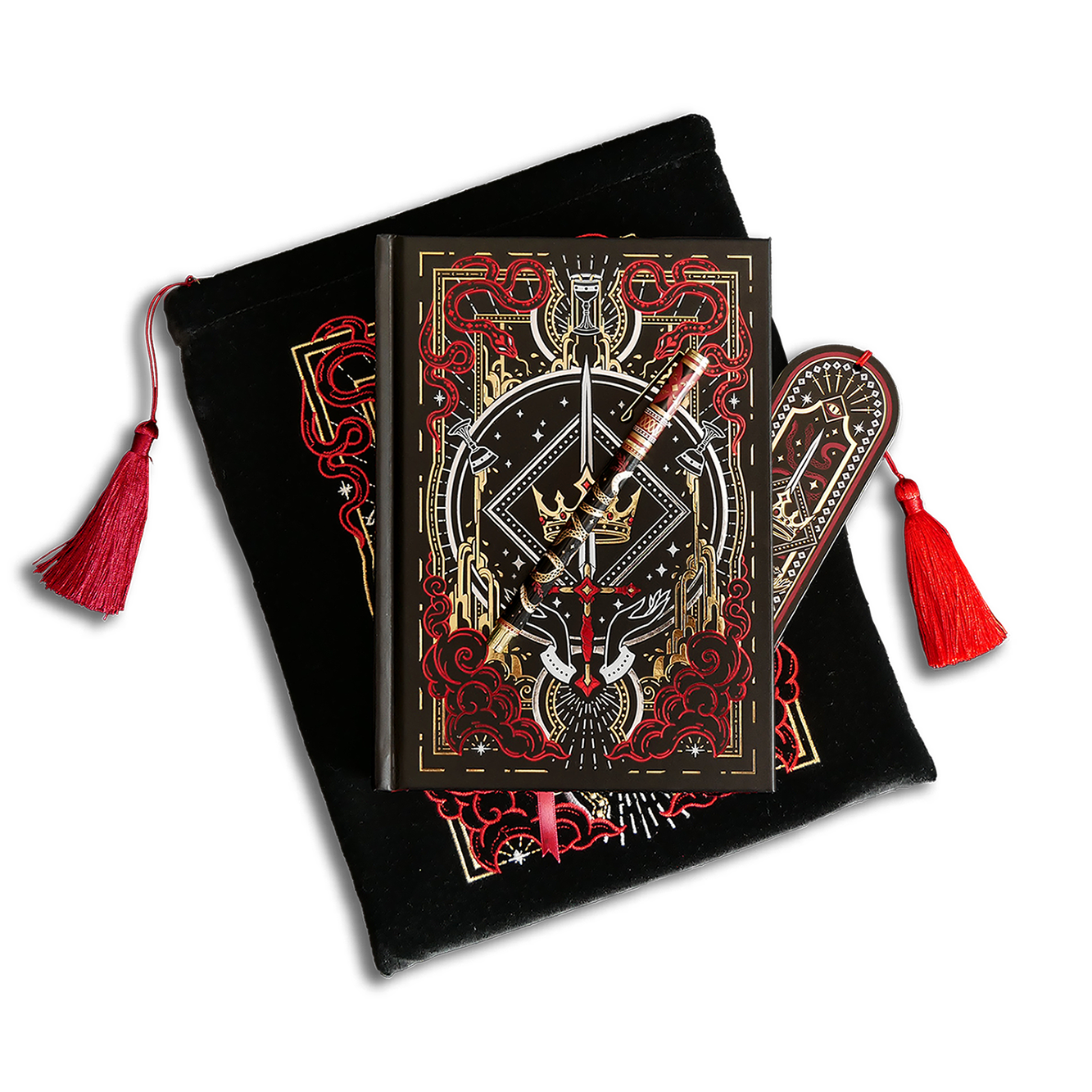 The Oathbreaker journal bundle shows a journal, pen, bookmark and embroidered book sleeve stacked ontop of each other. The romantasy inspired products are all black with red, white and gold detailing and all feature a design with a motif of hands, a crown, a sword, clouds and snakes.