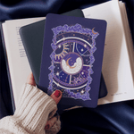 hand holding kindle and purple celestial inspired sticker that adheres to kindle