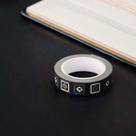 Black washi tape with white and grey flowers in squares outlined in gold foil