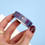 Blue washi tape with blue and purple flowers in pink and blue squares outlined in gold foil