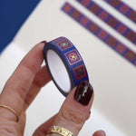 Blue washi tape with red and blue flowers in pink and red squares outlined in gold foil