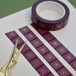 Purple washi tape with green and purple flowers in pink squares outlined in gold foil