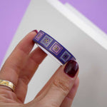 Purple washi tape with pink and purple flowers in light purple and pink squares outlined in gold foil
