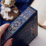 Blue faux leather reading journal with pink flowers, light blue leaves and gold foil filagree