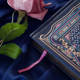 Blue faux leather reading journal with pink flowers, light blue leaves and gold foil filagree, and a pink ribbon bookmark