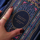 Blue faux leather reading journal with pink flowers, light blue leaves and gold foil filagree, and a pink ribbon bookmark