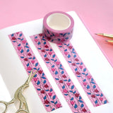 Pink washi tape with pink and red flowers with green leaves on a black vine