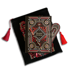 The Serpents & Swords Reading journal bundle shows a Reading journal, pen, bookmark and embroidered book sleeve stacked on top of each other. The romantasy inspired products are all black with red, white and gold detailing and all feature a design with a motif of hands, a crown, a sword, clouds and snakes.