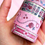 White and pink washi tapes with red roses, green leaves, cherries, hearts and handcuffs.