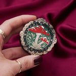 Decorative kindle grip with cottage core design held by a hand against a decorative background