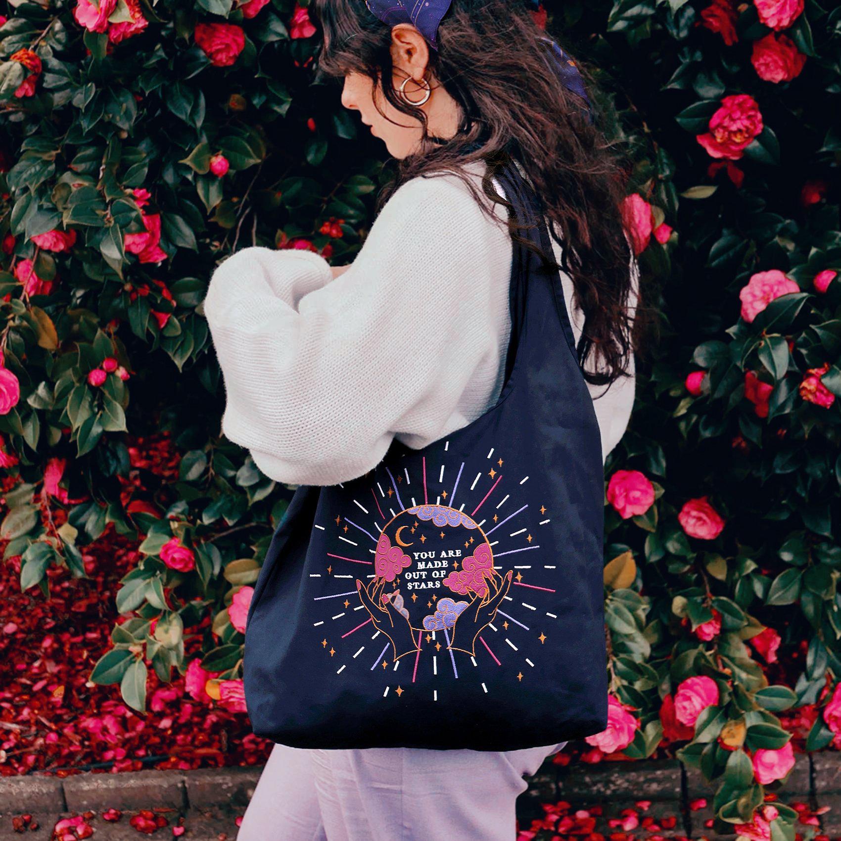 Navy Cotton Reusable Shopping tote bag. Colourful and gold moon and stars stitching embroidery. Eco friendly cotton bag, crystal ball design with 'You Are Made of Stars' text.