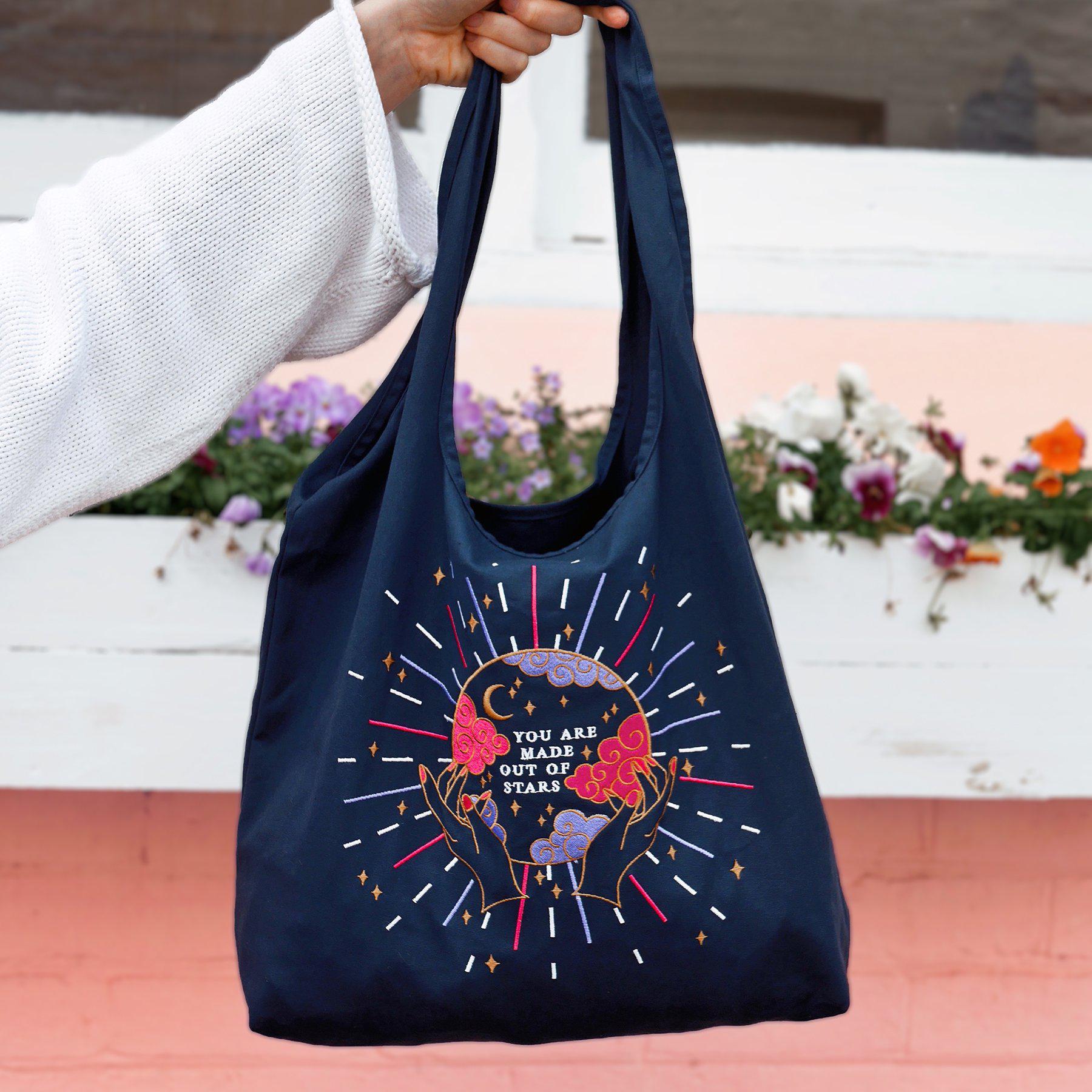 Navy Cotton Reusable Shopping tote bag. Colourful and gold moon and stars stitching embroidery. Eco friendly cotton bag, crystal ball design with 'You Are Made of Stars' text.