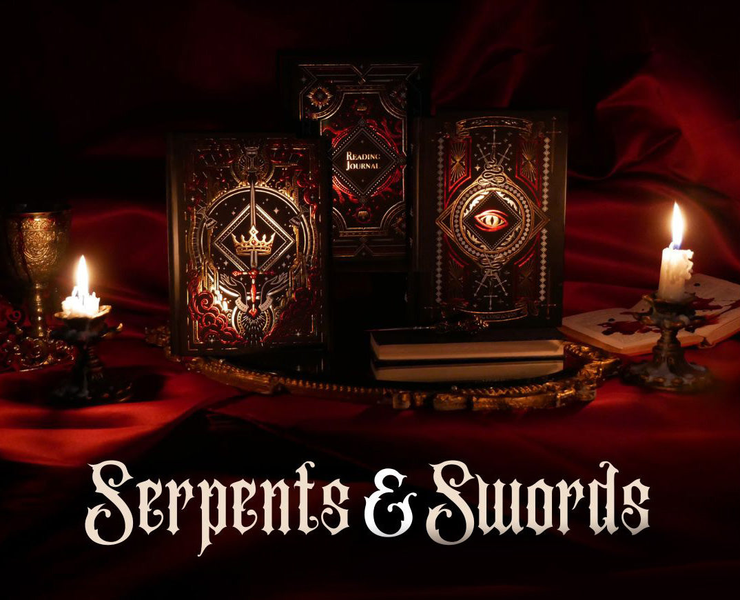 On a red fabric background sits the three journals for the Serpents & Swords collection- the journal, reading journal and reading companion. Sitting on a tray with two lit wax candles to the side, the journals are all black and feature intricate red and gold foiling that show motifs of snakes, swords, dragons, crowns, goblets and more from a romantasy book aesthetic. Underneath the image are the words "Serpents & Swords' in a medieval blackletter font.