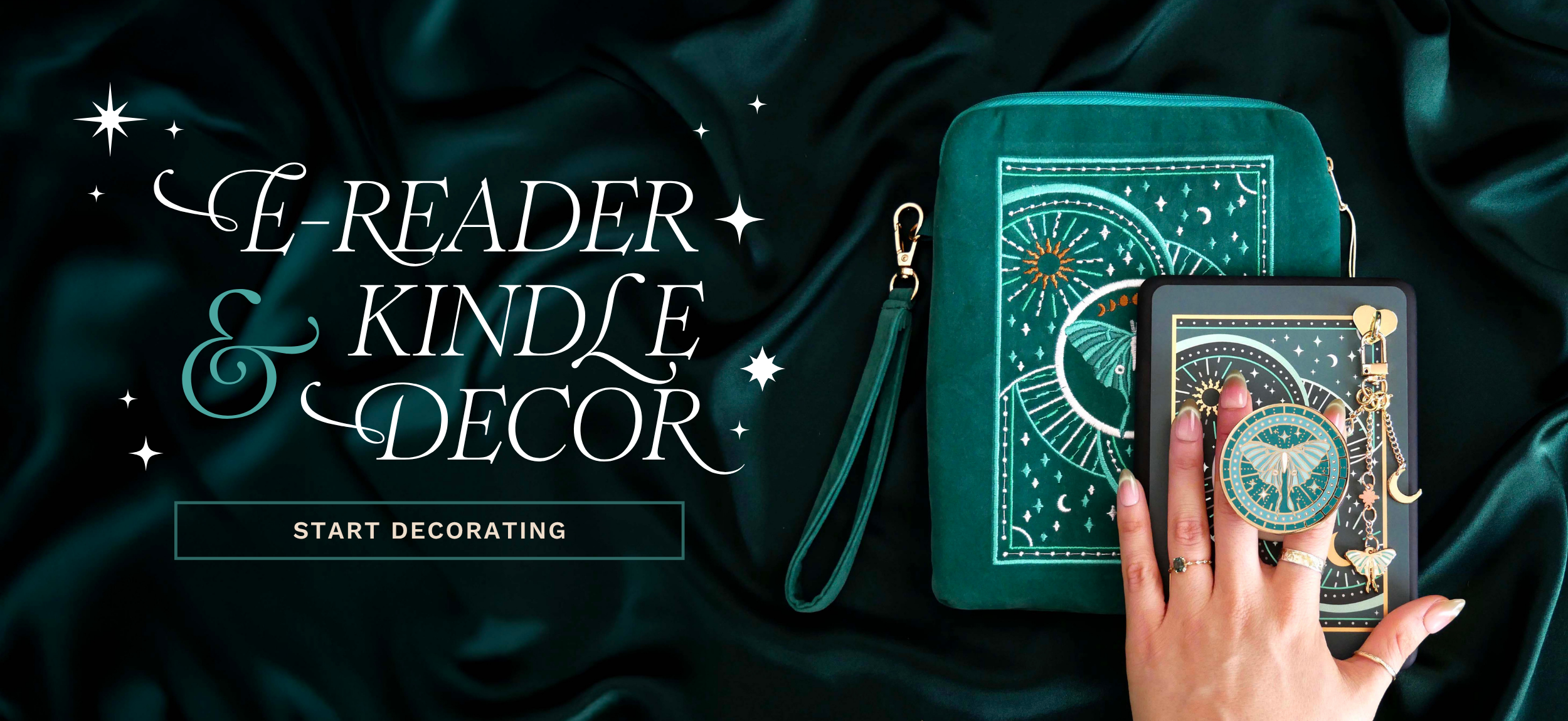 A graphic advertising The Quirky Cup Collective eReader and Kindle decor release. The teal Luna Moth bundle is shown with matching teal eReader case, sticker insert, clingie and charmlet being held by a hand on an emerald fabric background. very item has motifs of a aqua luna moth alongside moon, star and sun designs.