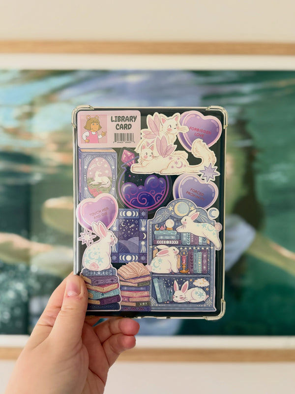 A collection of girly book inspired stickers stuck into the back of a clear kindle case.