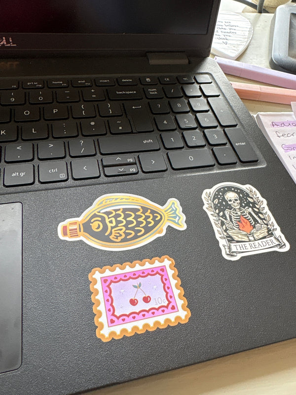 A collection of quirky sticker designs stuck to a laptop