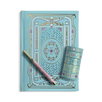 A decorative journal in Antoinette features a light blue foiled notebook with ornate gold filigree, a matching pen and a stack of matching washi tape.