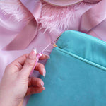 A detail of the aqua Kindle sleeve in Antoinette. The light green velvet Kobo case features pink, cream and gold embroidery with a classic book inspired design. Here the back of the case shows off the rear pocket and pastel pink tassel.