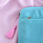 A detail of the aqua Kindle sleeve in Antoinette. The light green velvet Kobo case features pink, cream and gold embroidery with a classic book inspired design. Here the back of the case shows off the rear pocket and pastel pink tassel.