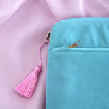 A detail of the aqua Kindle sleeve in Antoinette. The light green velvet Kobo case features pink, cream and gold embroidery with a classic book inspired design. Here the back of the case shows off the rear pocket and pastel pink tassel.
