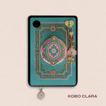 Decorated Kobo Clara with a set of aesthetic ereader accessories that are pastel teal and pink with gold hardware