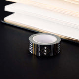 Roll of black washi tape with white flowers and leaves and gold foil