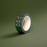 The Sage green variation of the Aurum Literati washi tape. The book inspired washi tape design is shown on a green background and features a geometric design inspired by classical book ornaments in shades of dark green, sage green and gold.