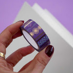 Roll of purple washi tape with pink flowers, light blue leaves and gold foil