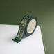 The Sage green variation of the Balteus Literati washi tape. The classic book inspired washi tape design is shown on the corner of a journal page on a green background and features a classic victorian motif with a small flower in shades of dark green, sage green, white and gold.